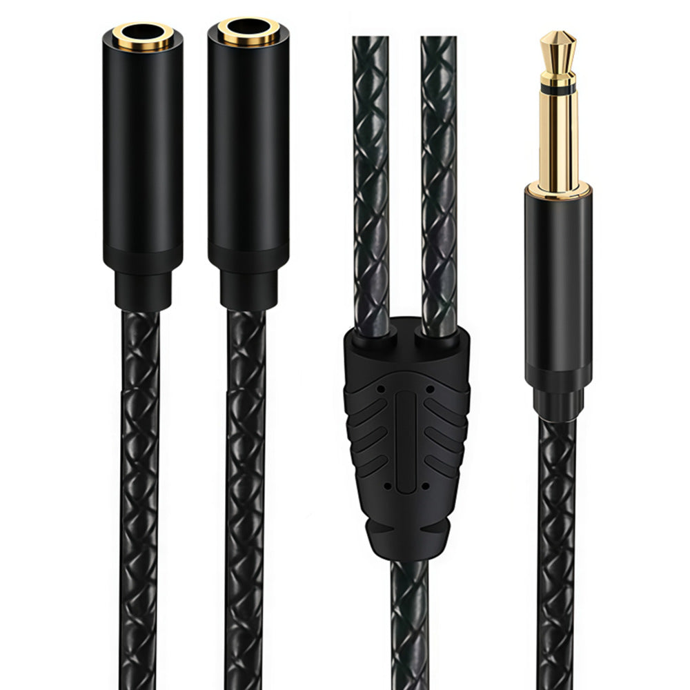 Close-up of a black braided Y audio cable showing one straight mono male plug, two female sockets and the splitter junction