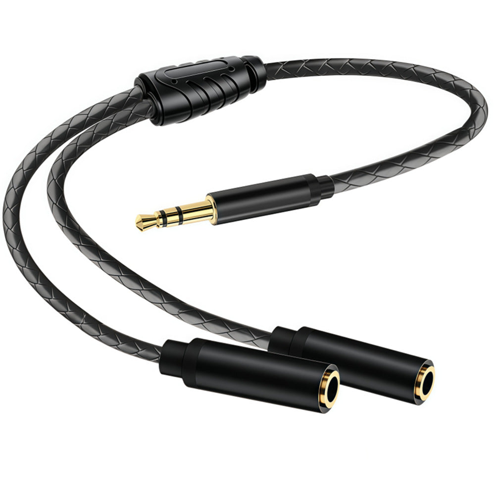 Close-up of the braided cable, Y-junction and connectors on a black 3.5mm TRS audio splitter