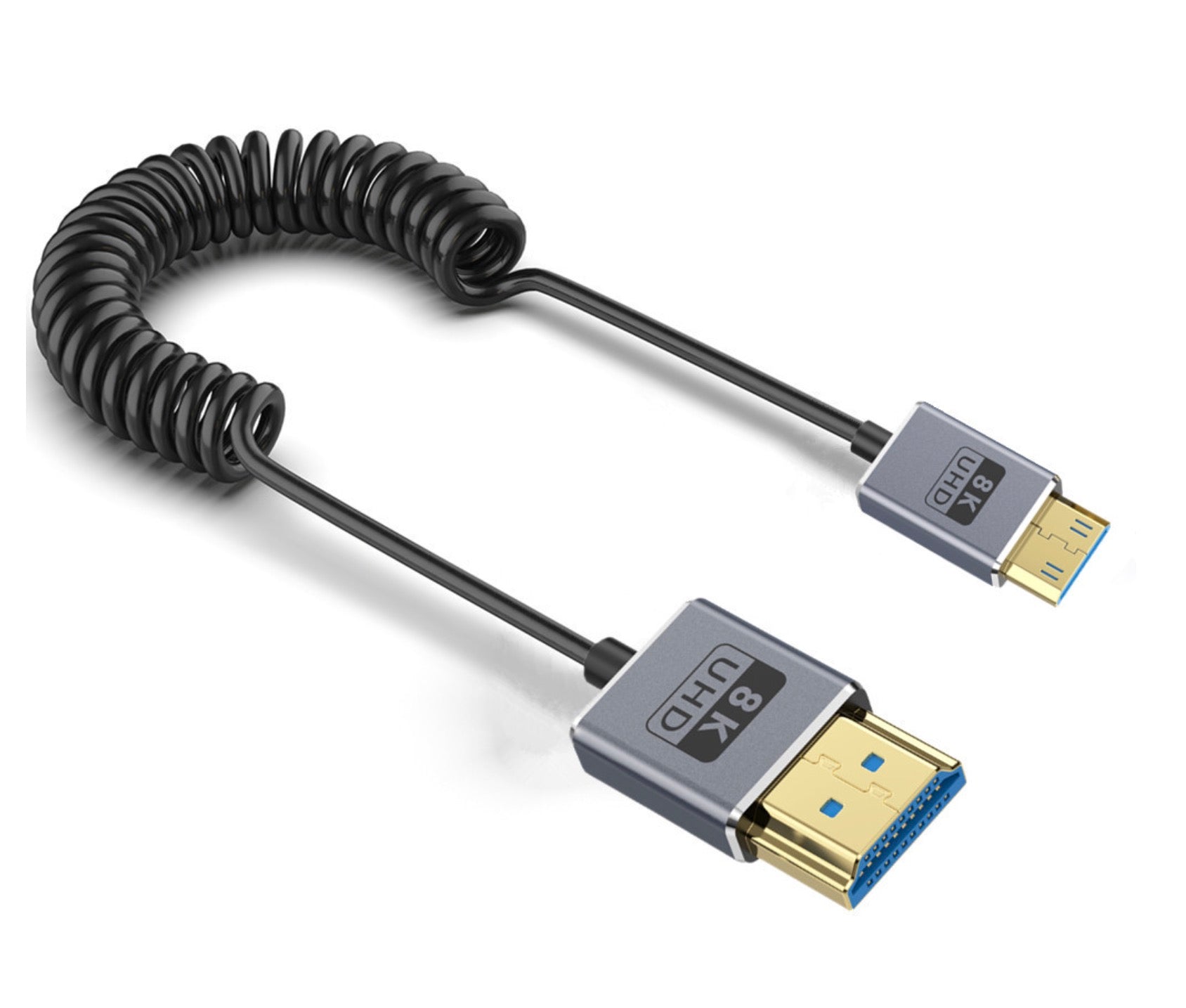 A coiled Mini HDMI to HDMI cable, with one end being thinner and labeled 'Mini HDMI' and the other end being thicker and labeled 'HDMI'.