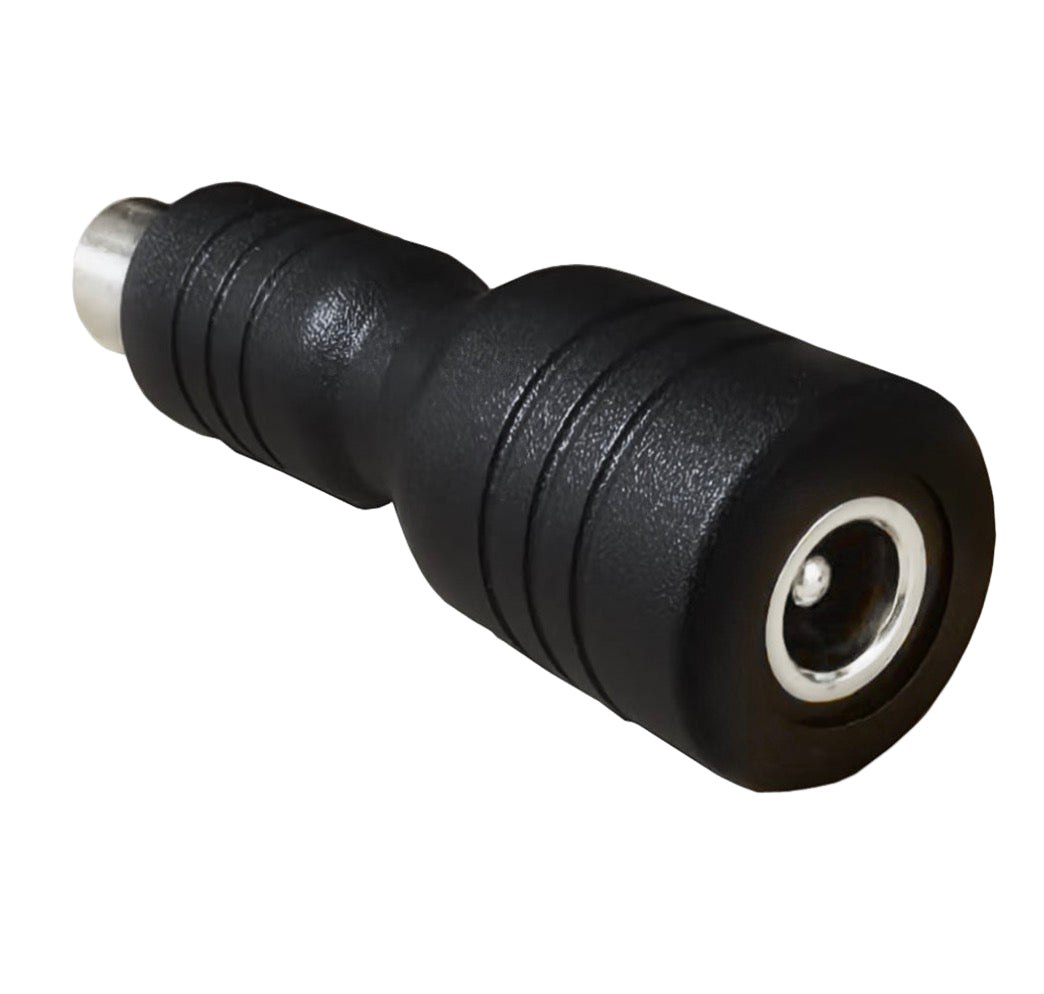 Black DC power adapter plug on a white background