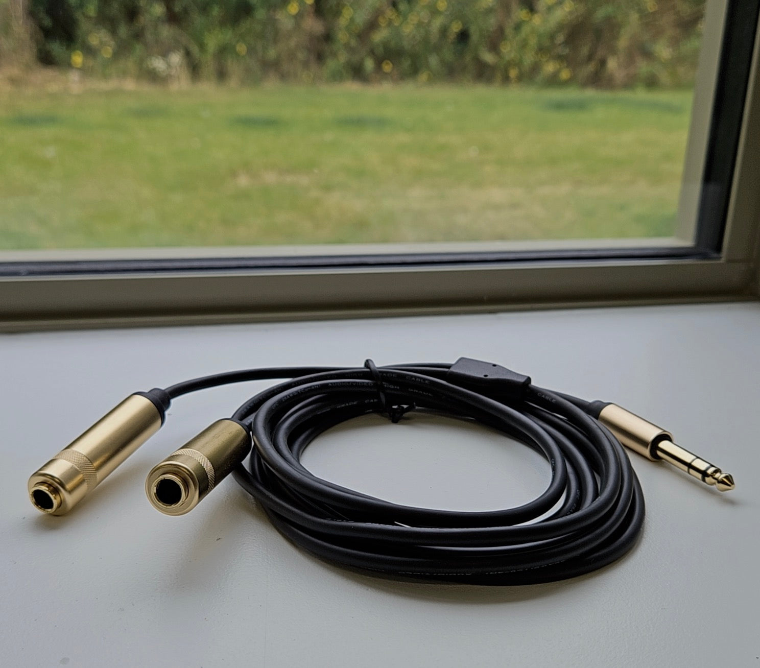 Stereo splitter cable connected to audio mixer and headphone