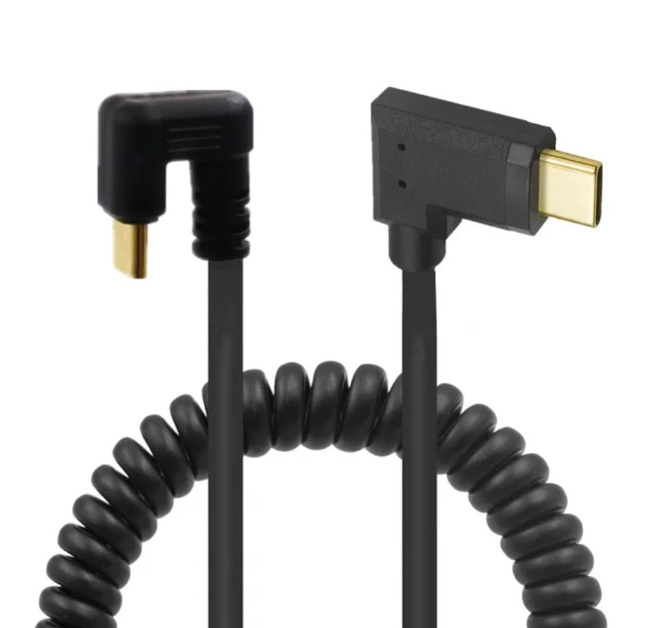 Black coiled cable with gold connectors on a white background