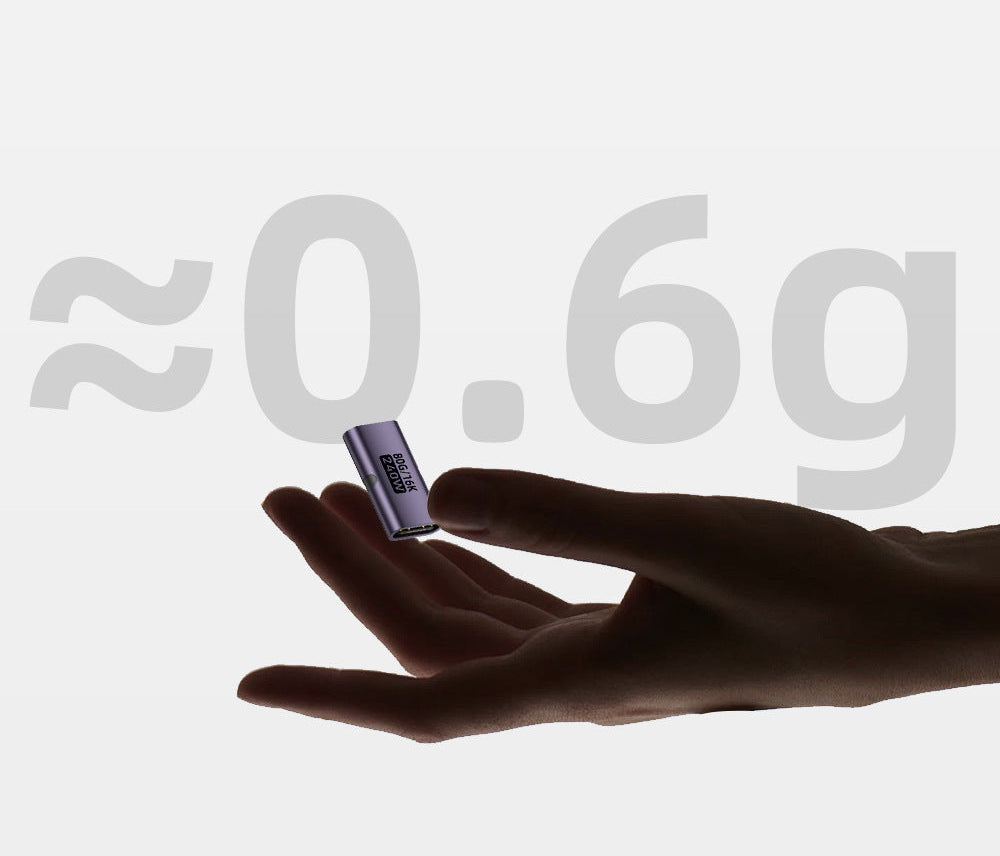 Hand holding a small purple device with '0.6g' displayed on a white background