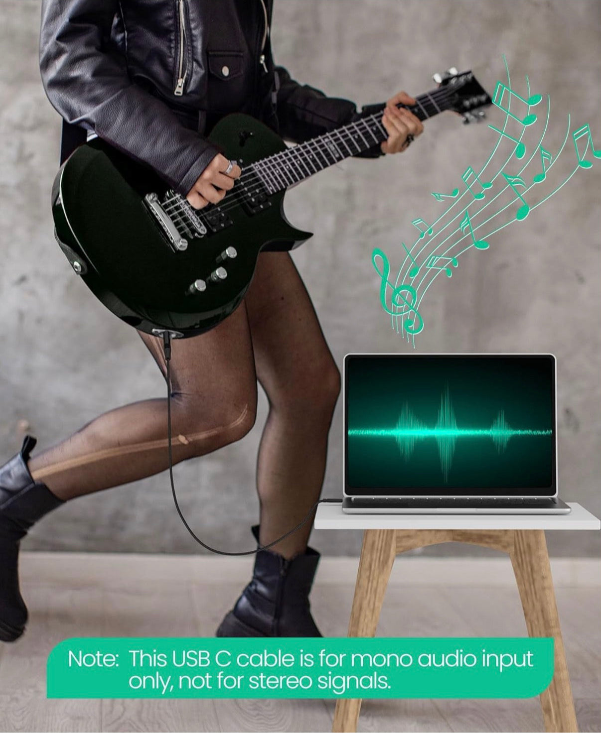 Person playing electric guitar with USB cable to laptop.