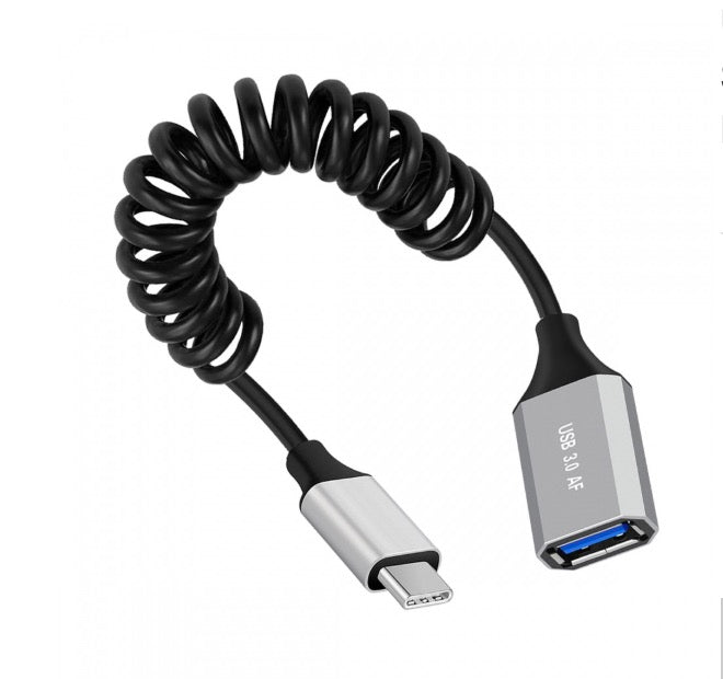 A black coiled cable with a USB-C male connector on one end and a USB 3.0 A female connector on the other, wrapped around a spring mechanism.
