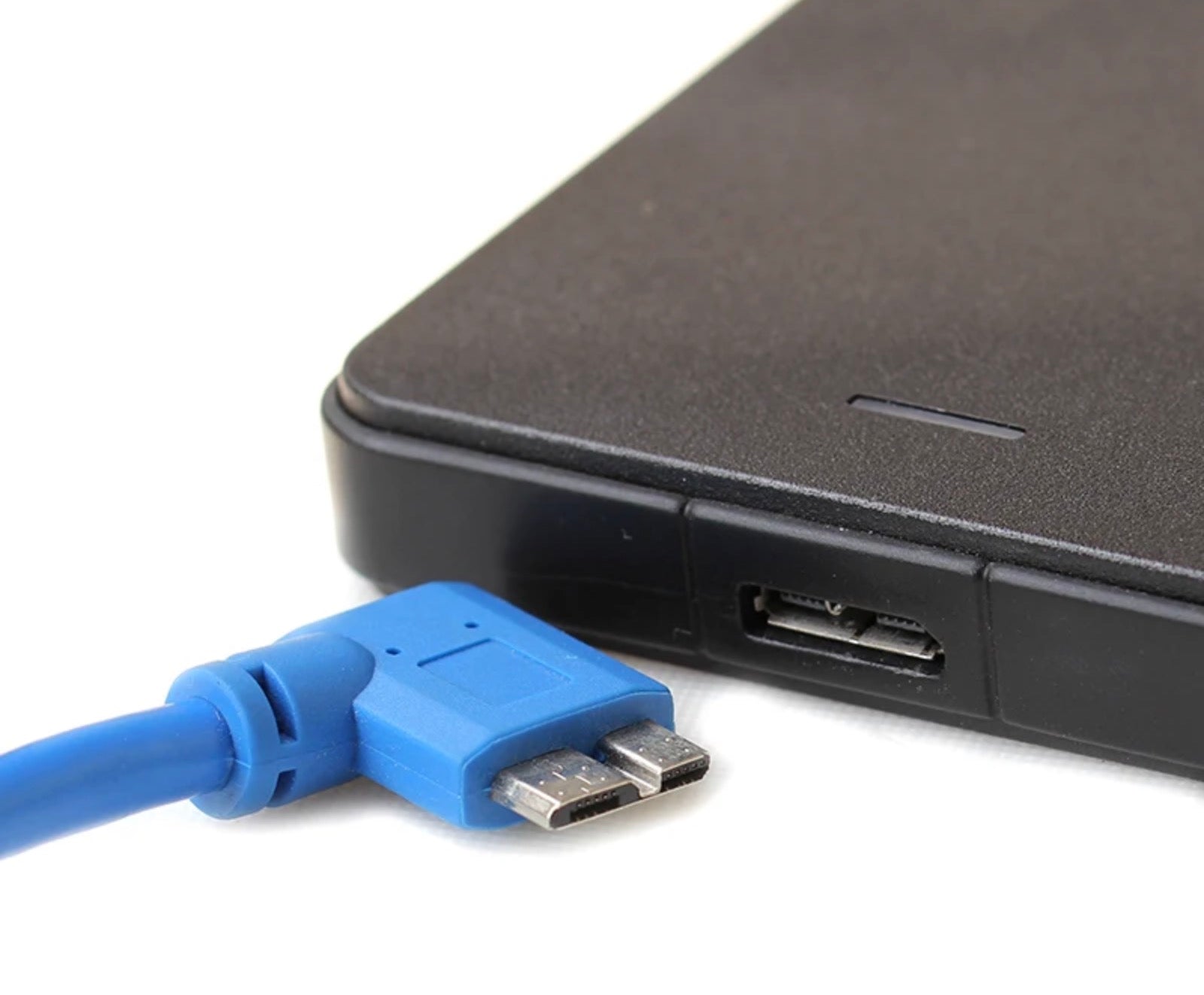 USB 3.0 Type-A to Micro-B right angle cable connected to an external hard drive for high-speed data transfer