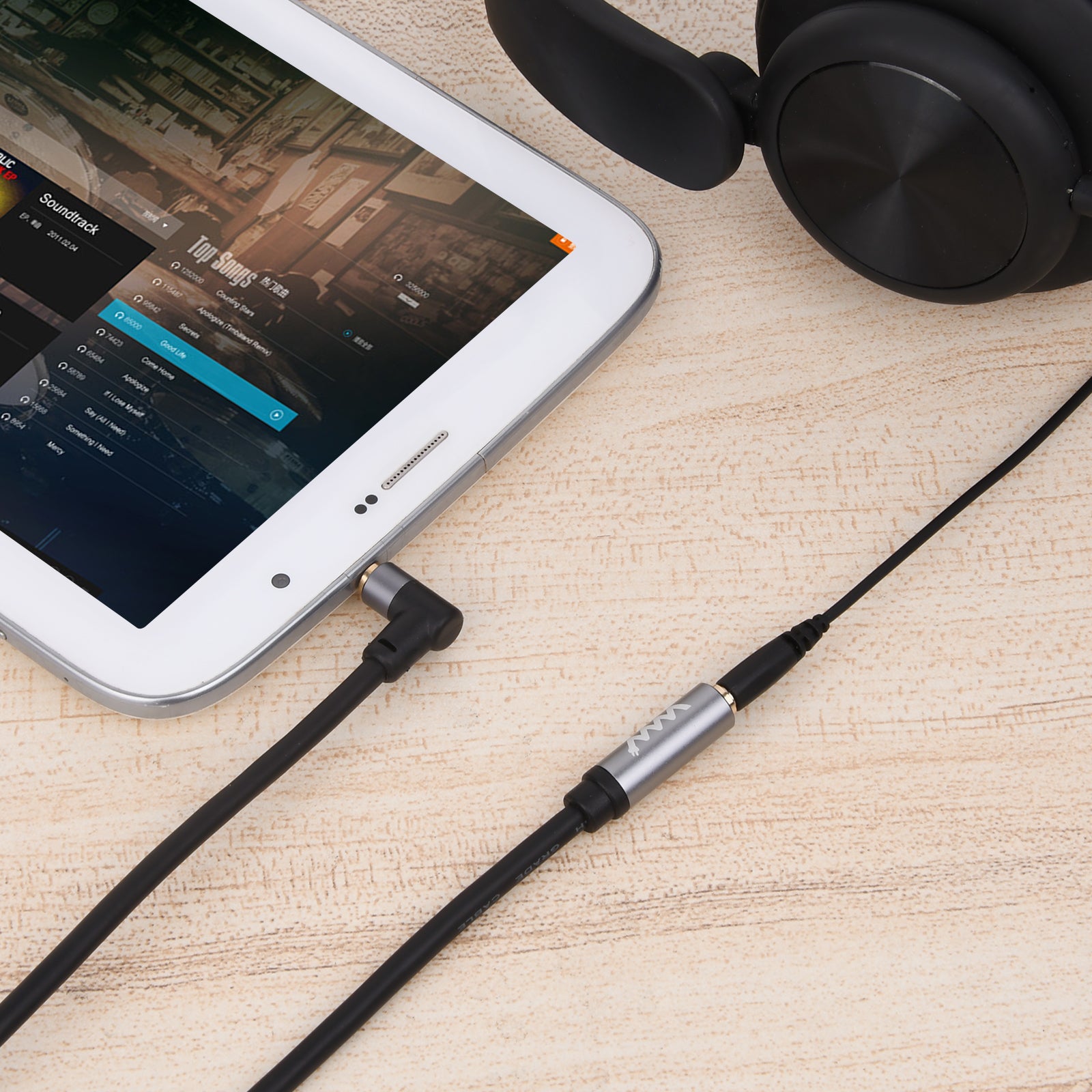 AUX extension cable connected to smartphone and headset.
