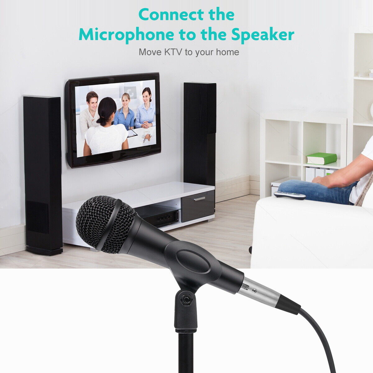 Microphone connected to a speaker system with a TV in the background displaying people on a video call.