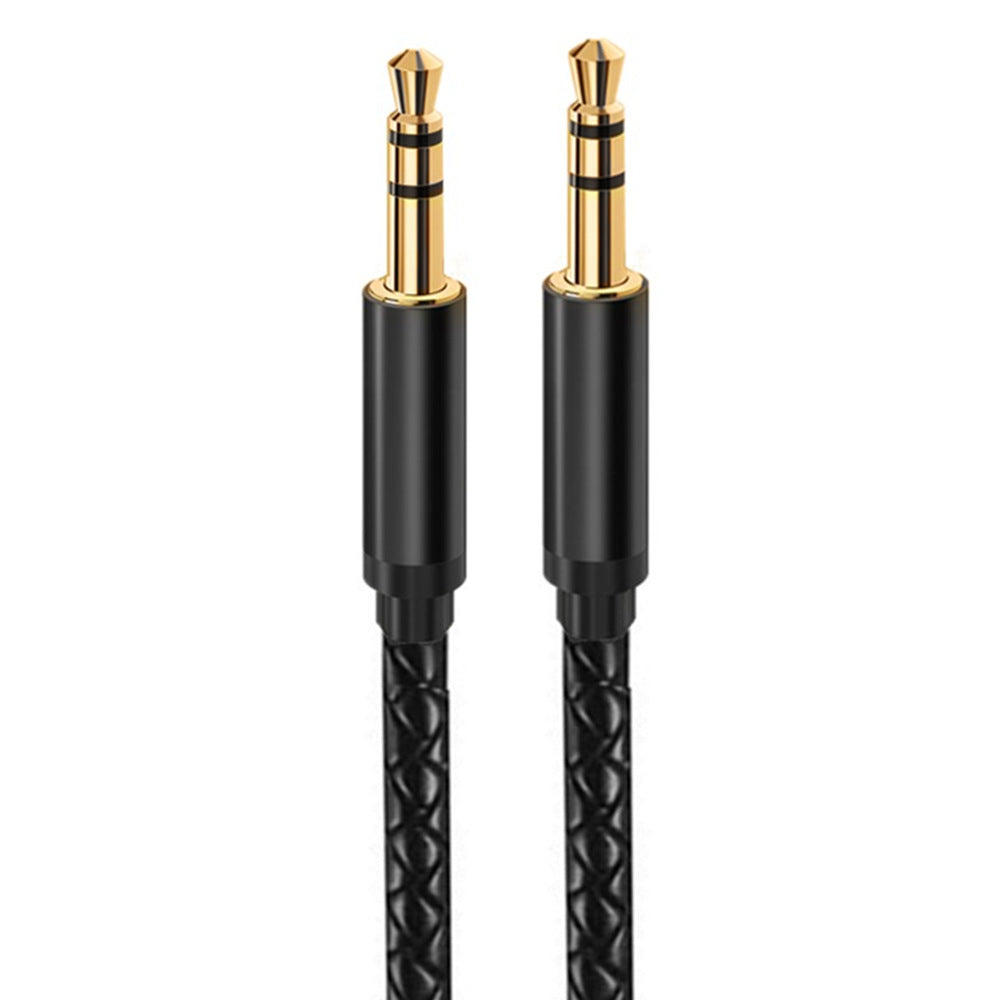 Close-up of two straight 3.5mm TRS male plugs with black metal housings and braided cable