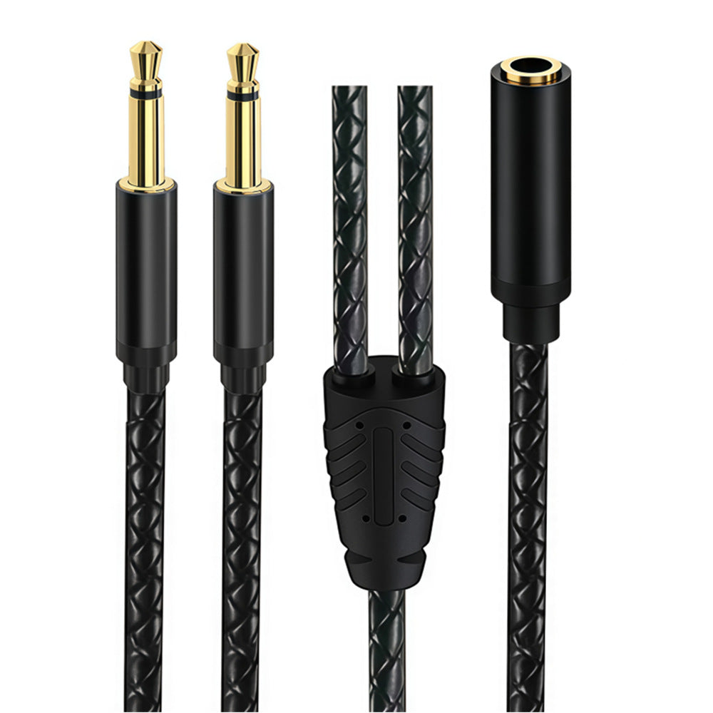 Close-up of a black braided Y audio cable showing one 3.5mm female socket, two straight mono male plugs and the splitter junction
