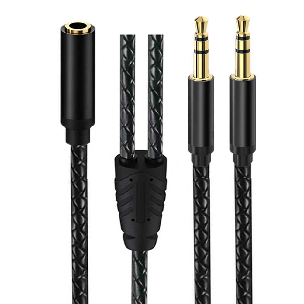 Close-up of a black braided 3.5mm TRS Y-splitter showing one female socket and two male 3-pole plugs