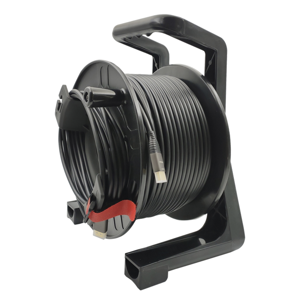 Black cable reel with coiled cable on a white background