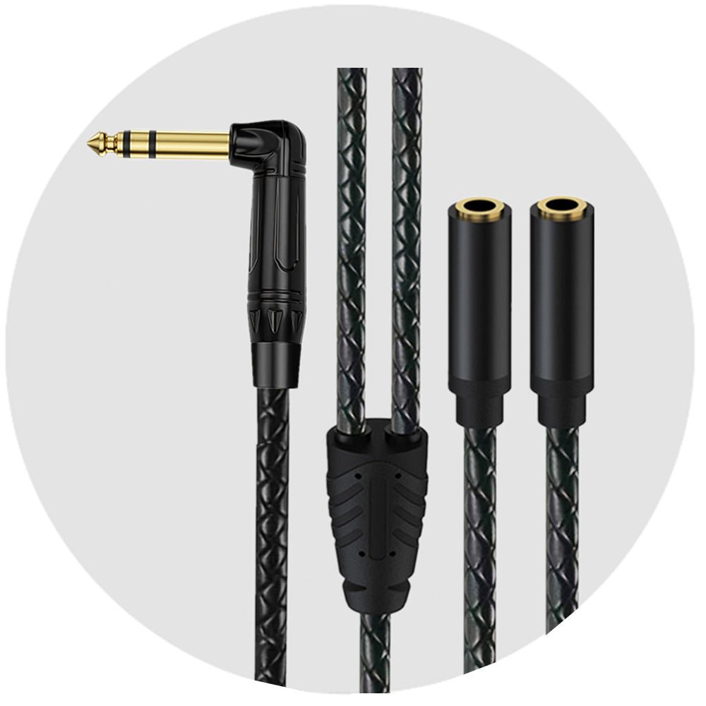 Black audio cable with gold connector on a white background
