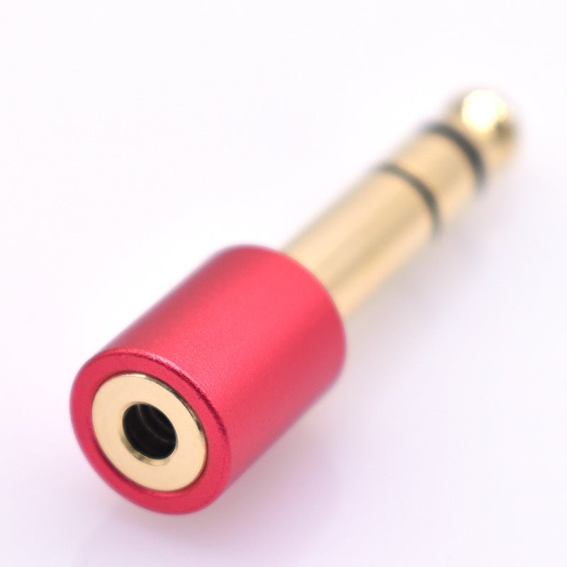 Red and gold audio adapter on a white background