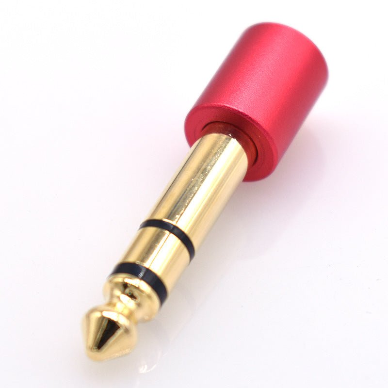 Red and gold audio plug on a white background