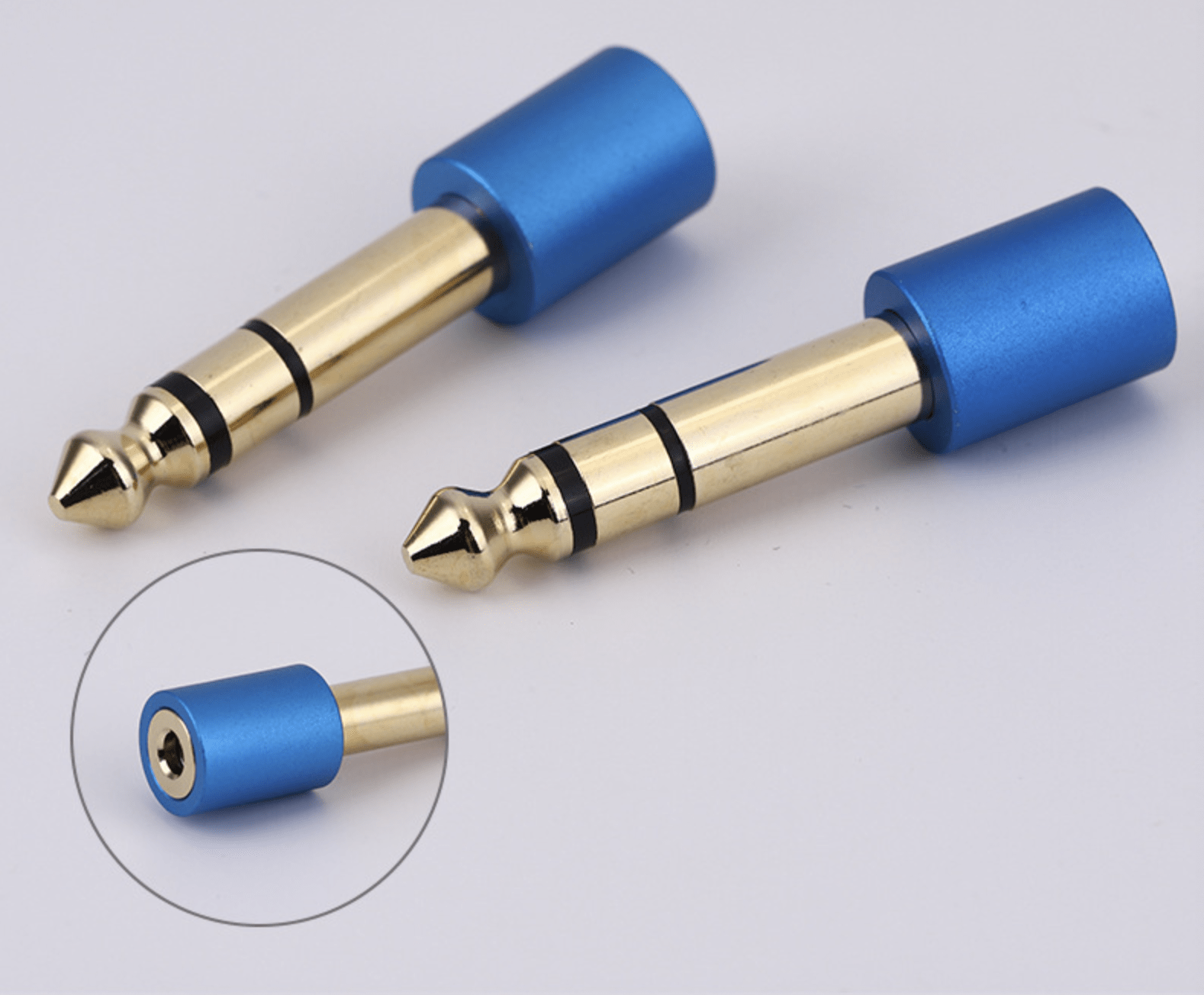 Two audio plug connectors with blue and gold finishes on a light gray background.