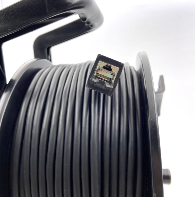 Close-up of RJ45 connector on CAT6A outdoor Ethernet cable reel.