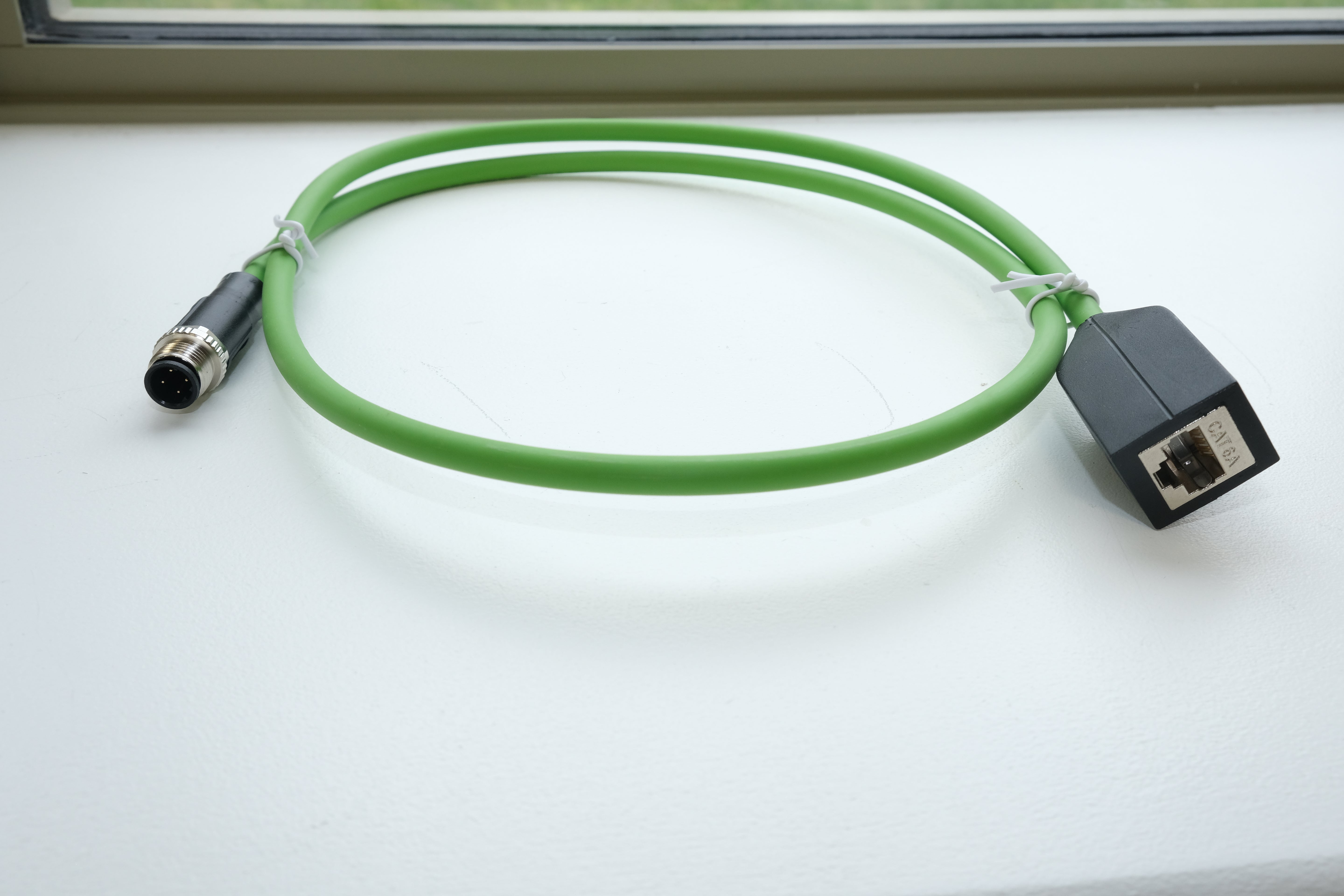 Green cable with connectors on a white background