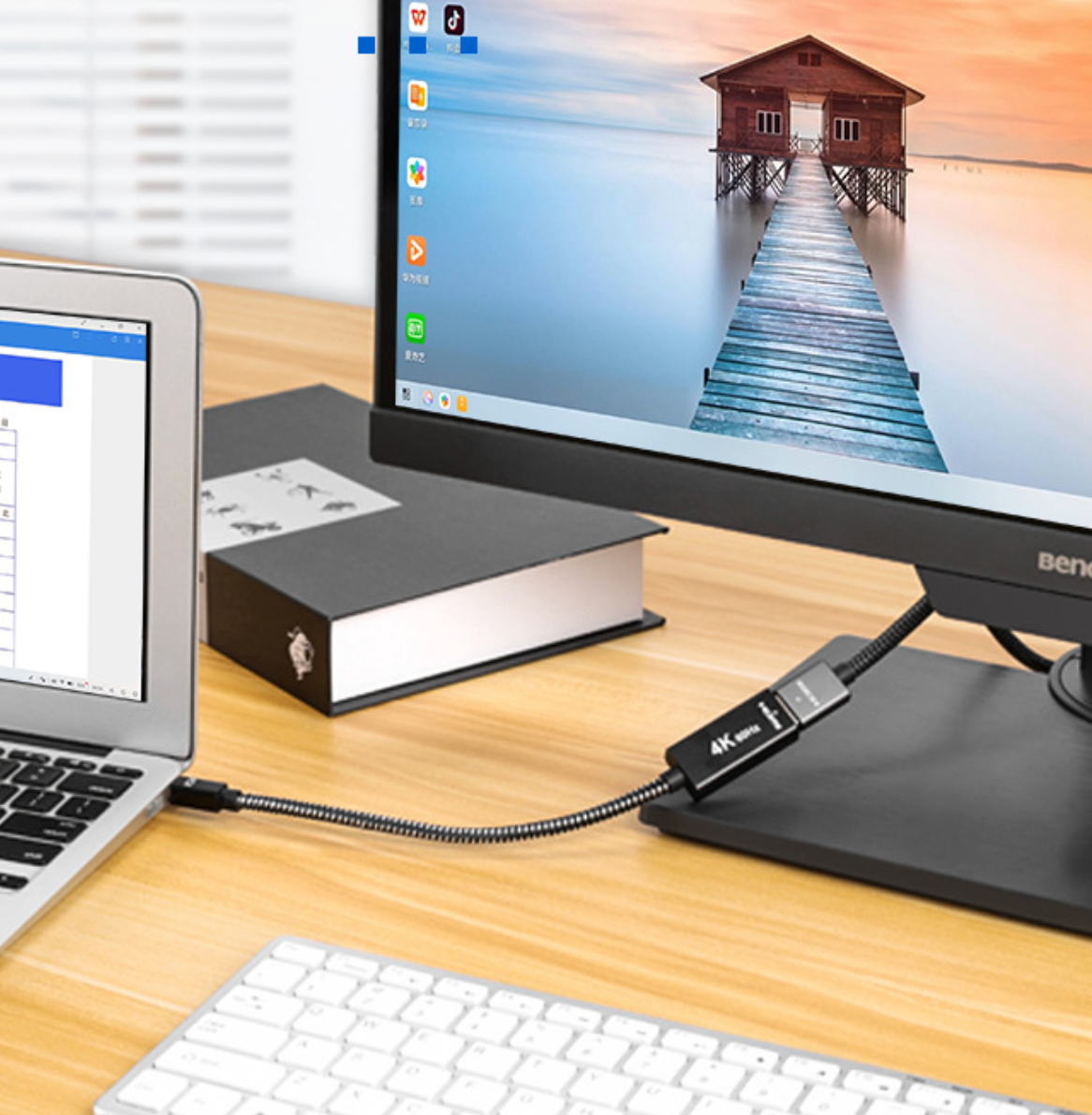 USB extension cable connecting a laptop to a monitor on a desk