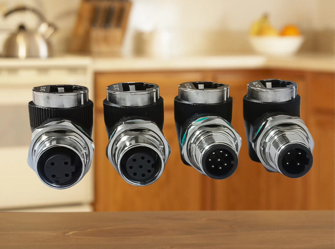 Four metallic connectors on a kitchen counter with blurred background