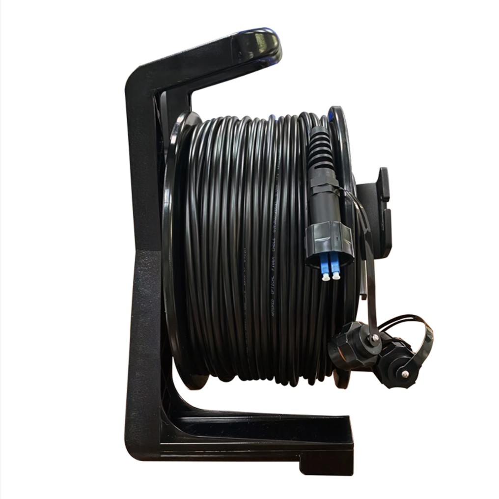 Black cable reel with coiled cable on a white background