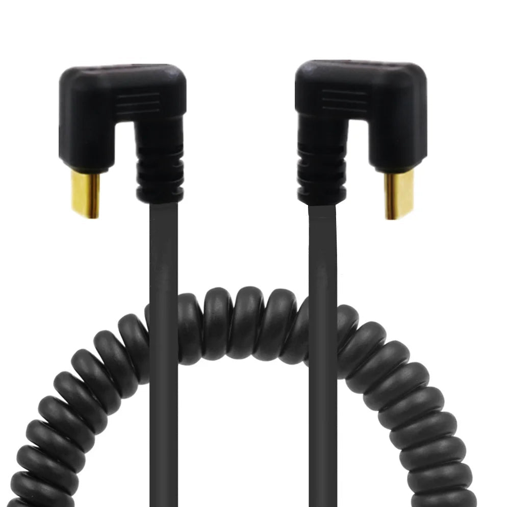 Two black spiral extension cords with gold connectors on a white background