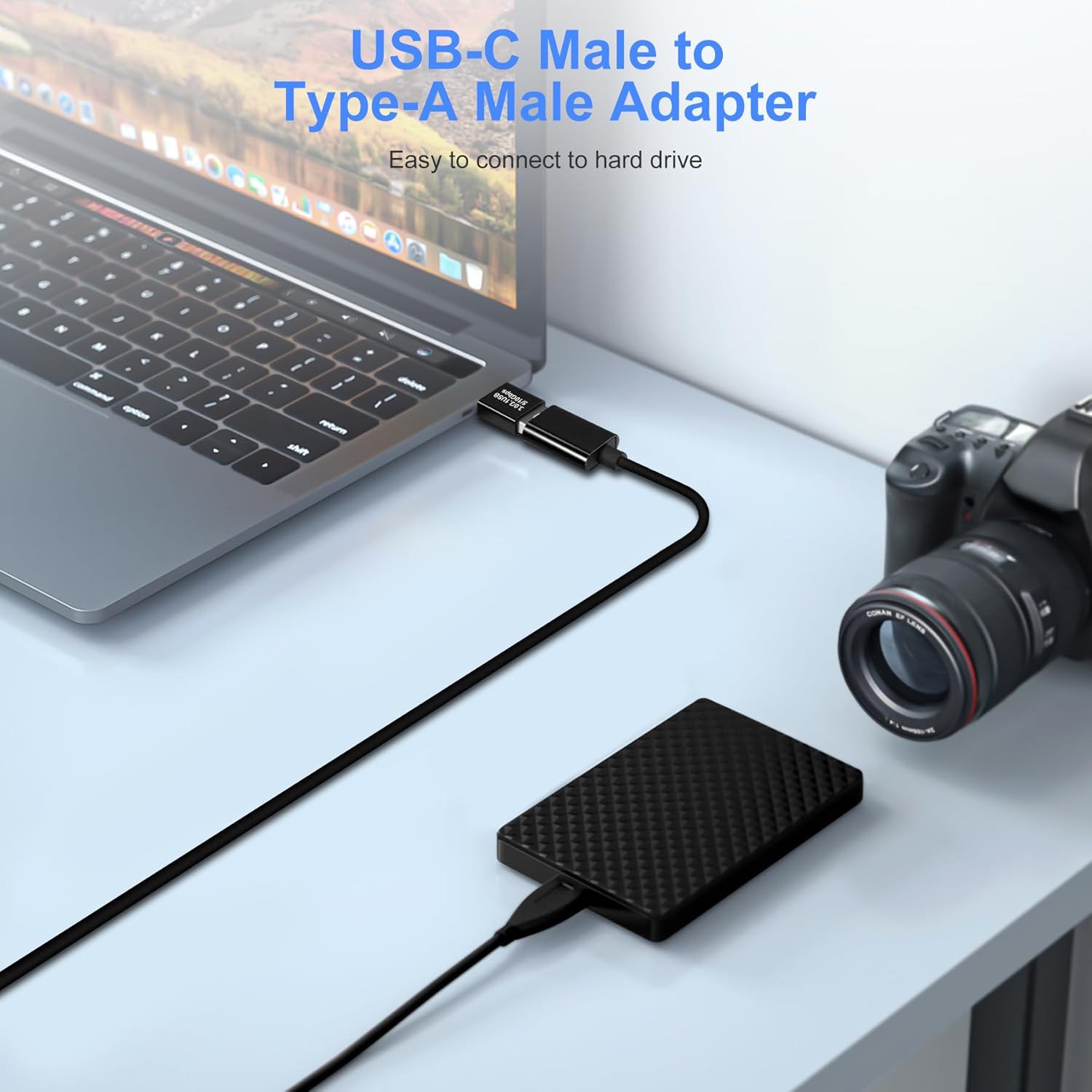 USB-C Male to Type-A Male Adapter connected to a laptop and camera on a white surface.