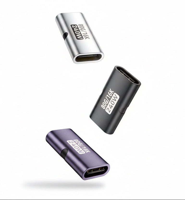 Four USB adapters of different colors on a white background