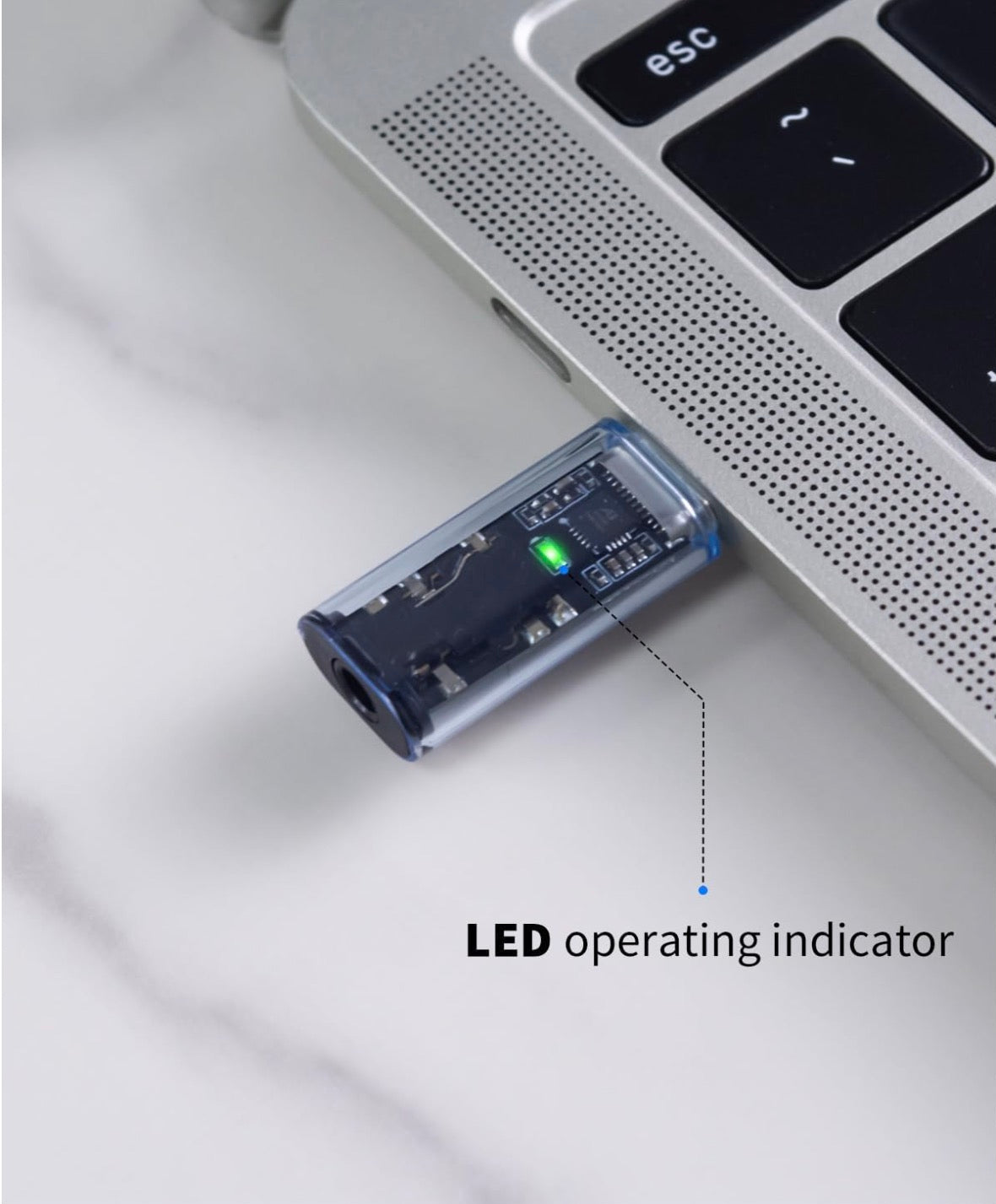 USB adapter with LED indicator on a laptop
