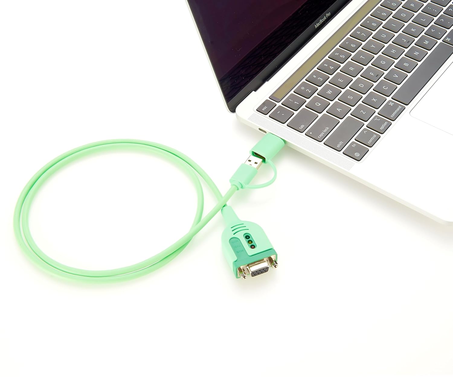 Green USB cable connected to a laptop on a white background