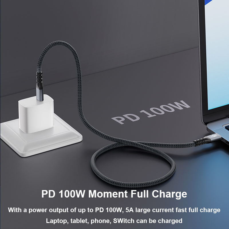 PD 100W power adapter and cable with a laptop on a dark surface