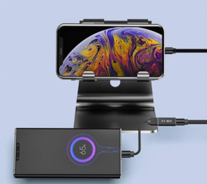 Phone dock with smartphone displaying colorful screen and power bank on a light blue background