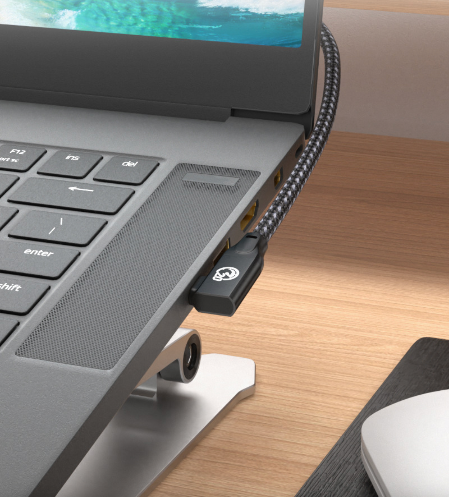 Laptop with a USB-C hub attached on a wooden desk