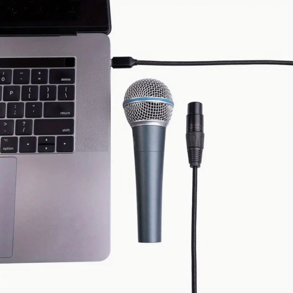 Microphone connected to a laptop with a cable.