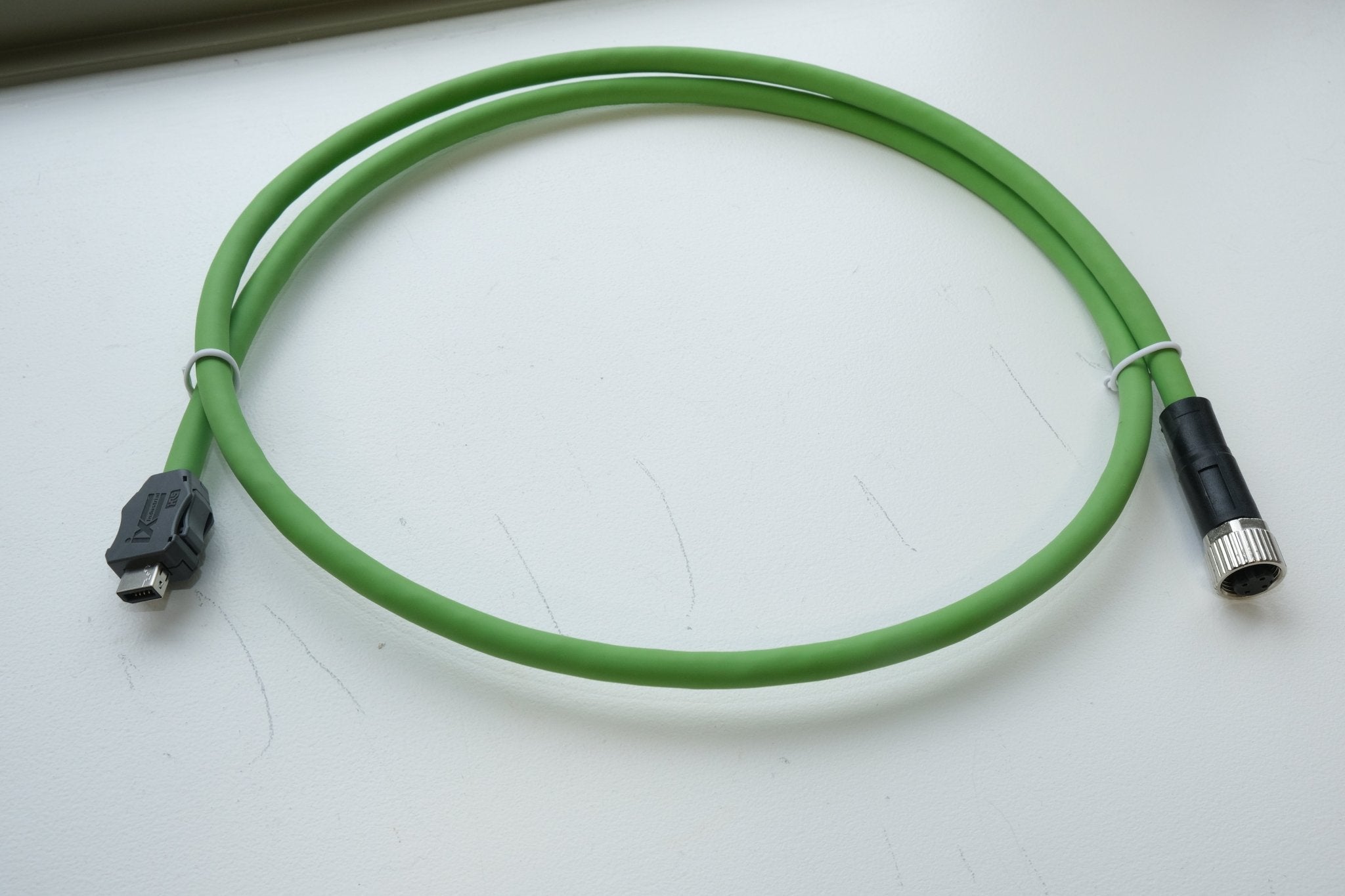 Green cable with connectors on a white background