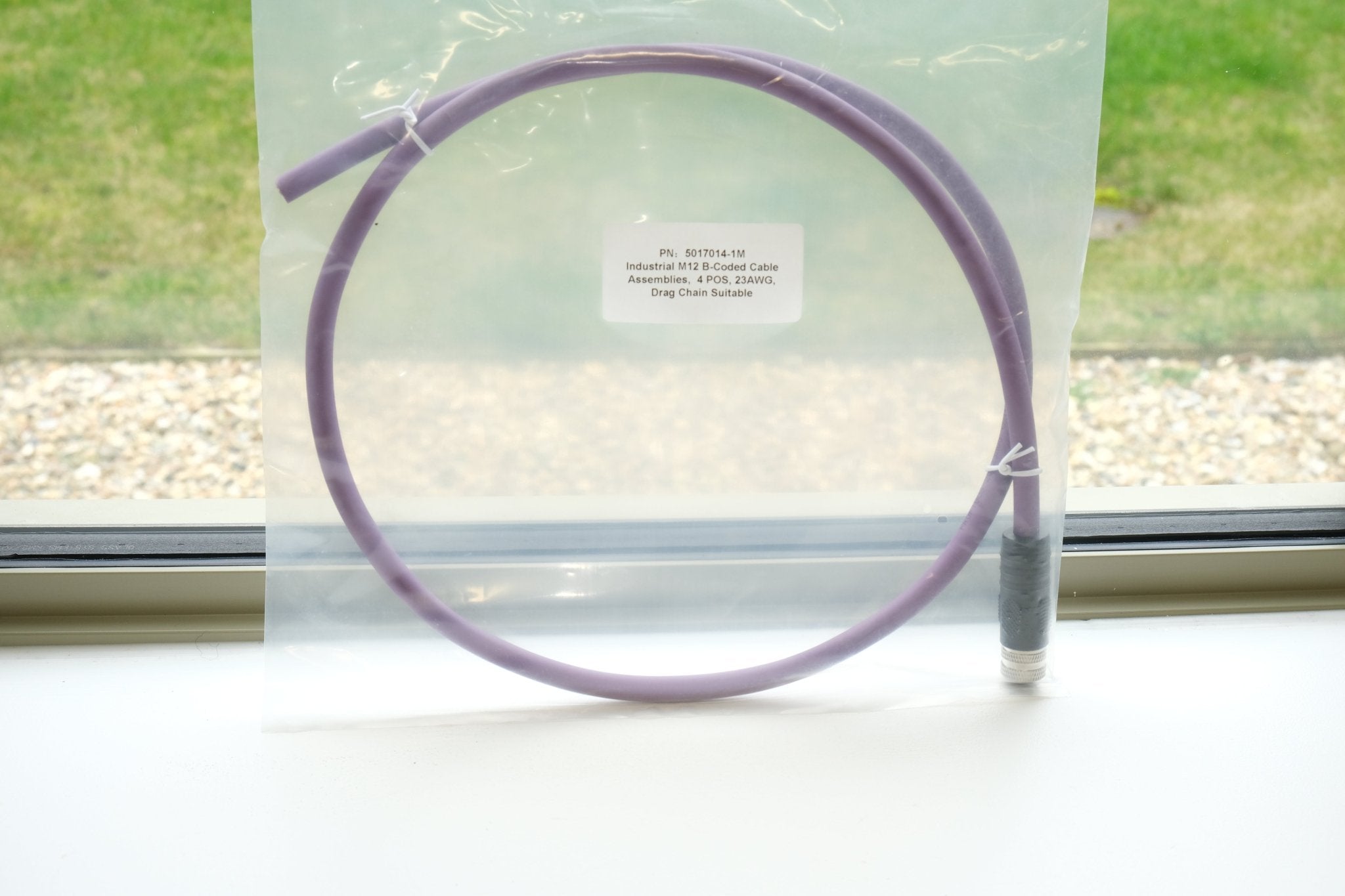 Purple circular object on a white surface with a window in the background