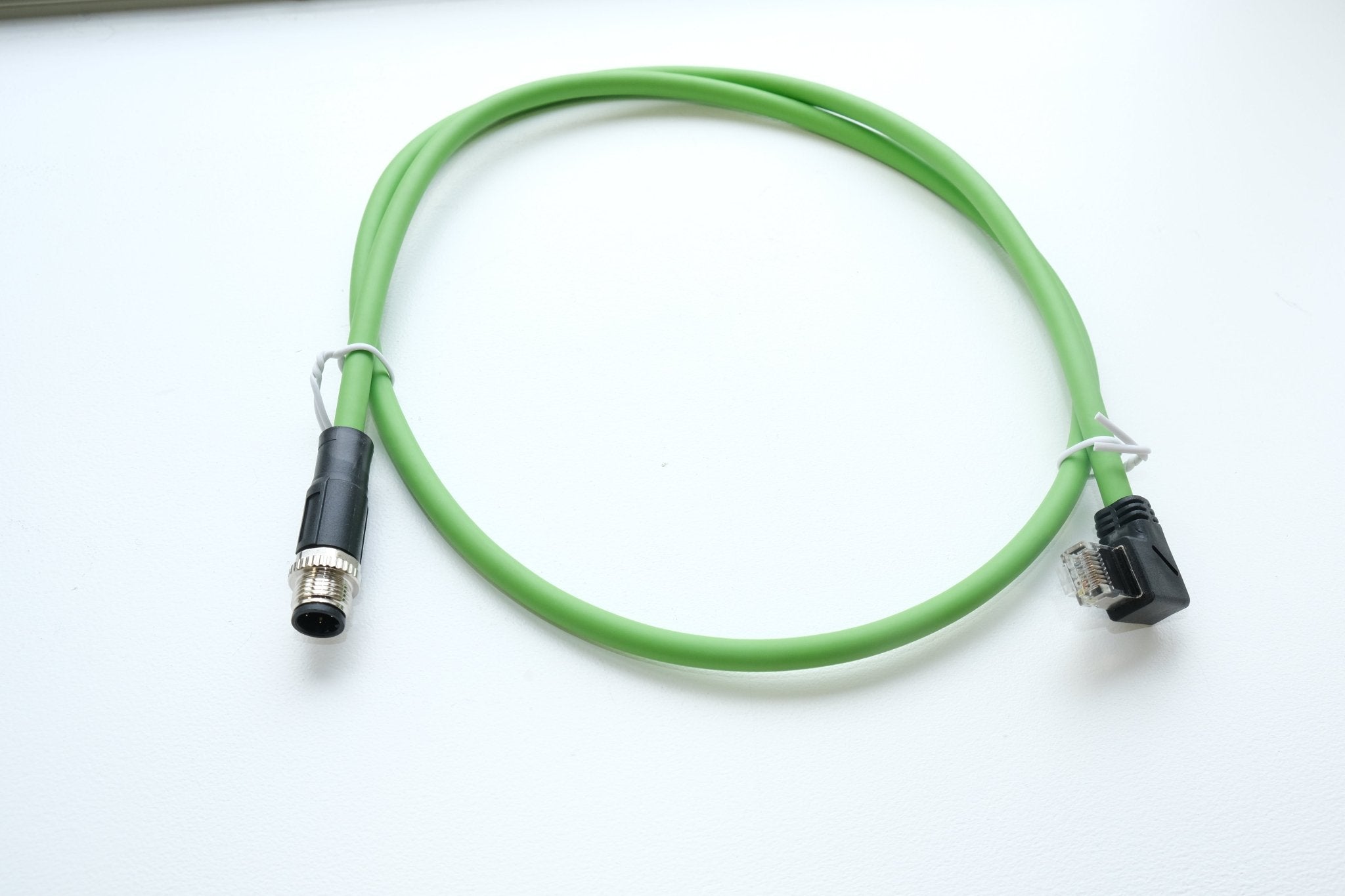 Green cable with connectors on a white background