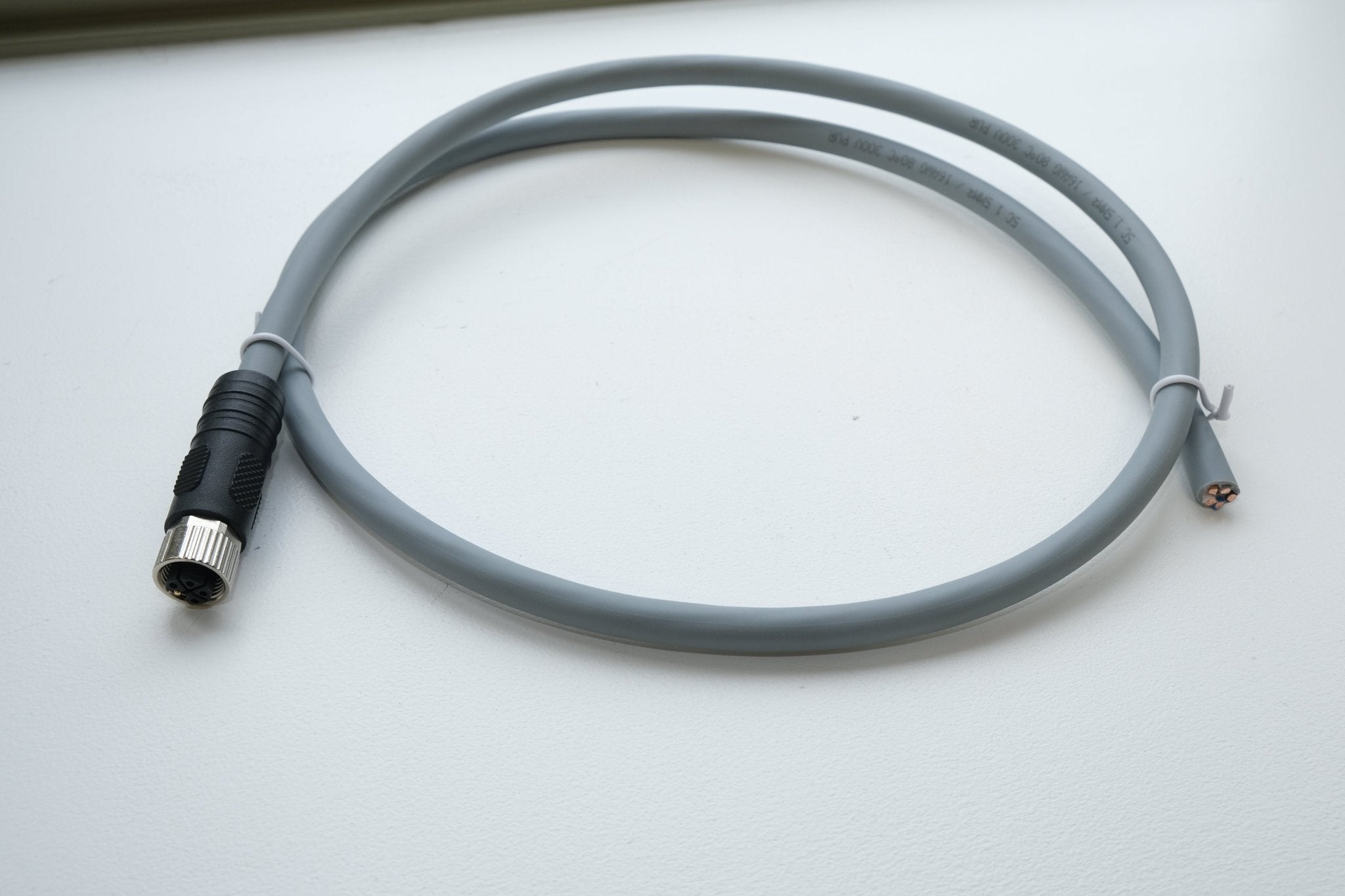 Gray cable with connectors on a white background