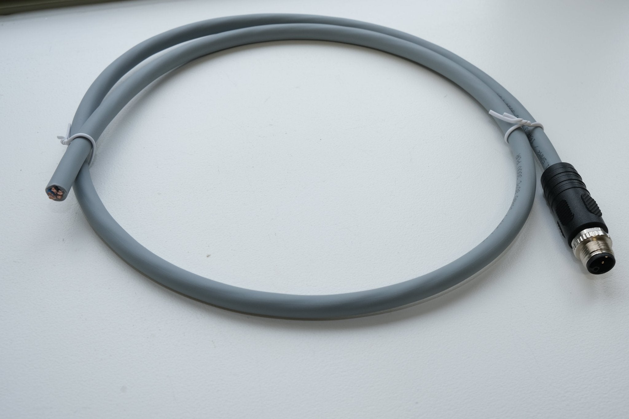 Gray cable with connectors on a white background