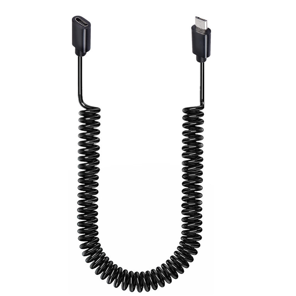 A black coiled charging extension cable with a Micro USB 5 Pin Male to Female connector on one end and a standard USB connector on the other, against a white background.