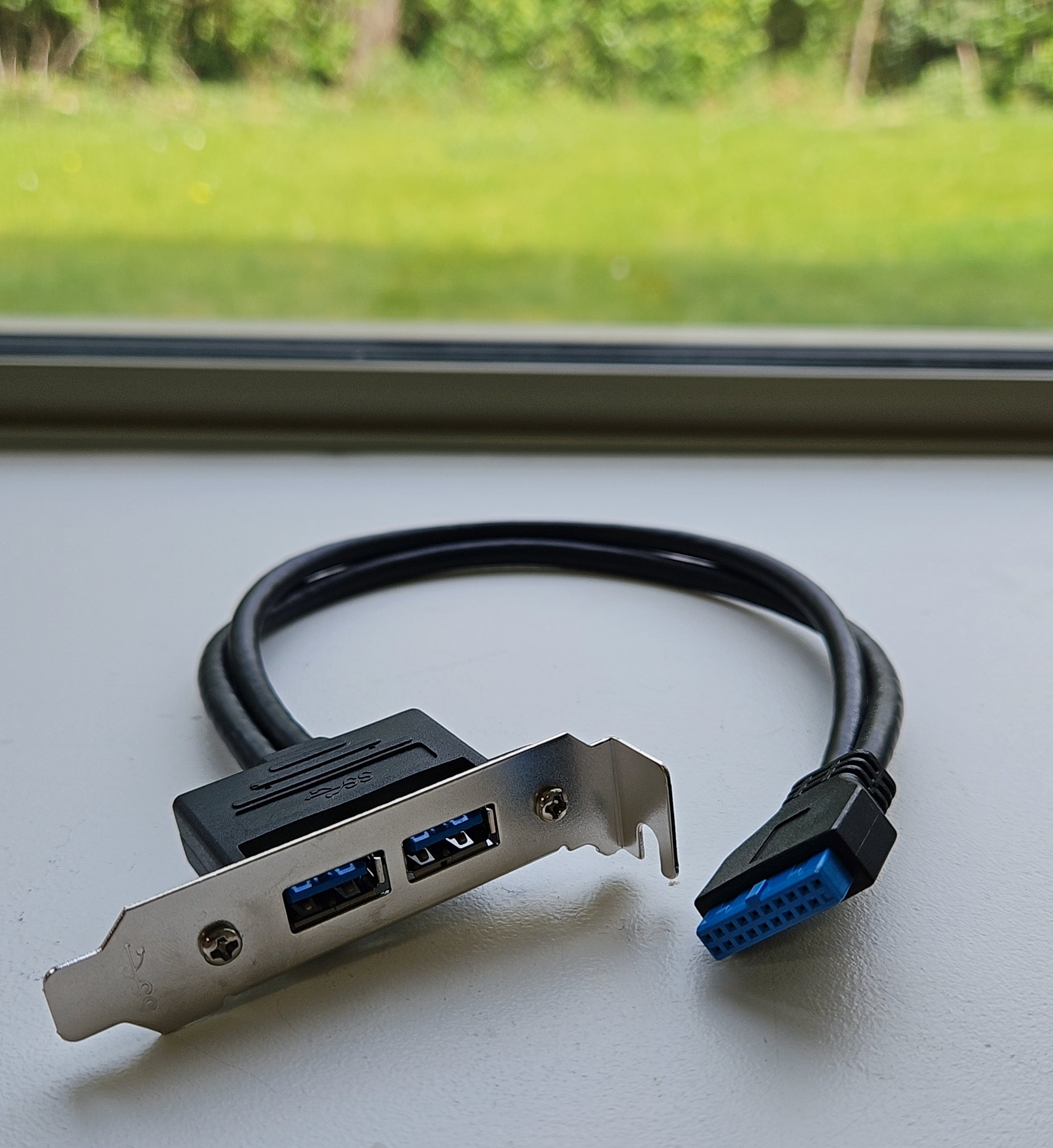 Computer hardware component with USB connectors on a white surface