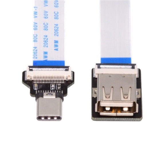 Close-up of a USB Type-C connector and a flat cable on a white background