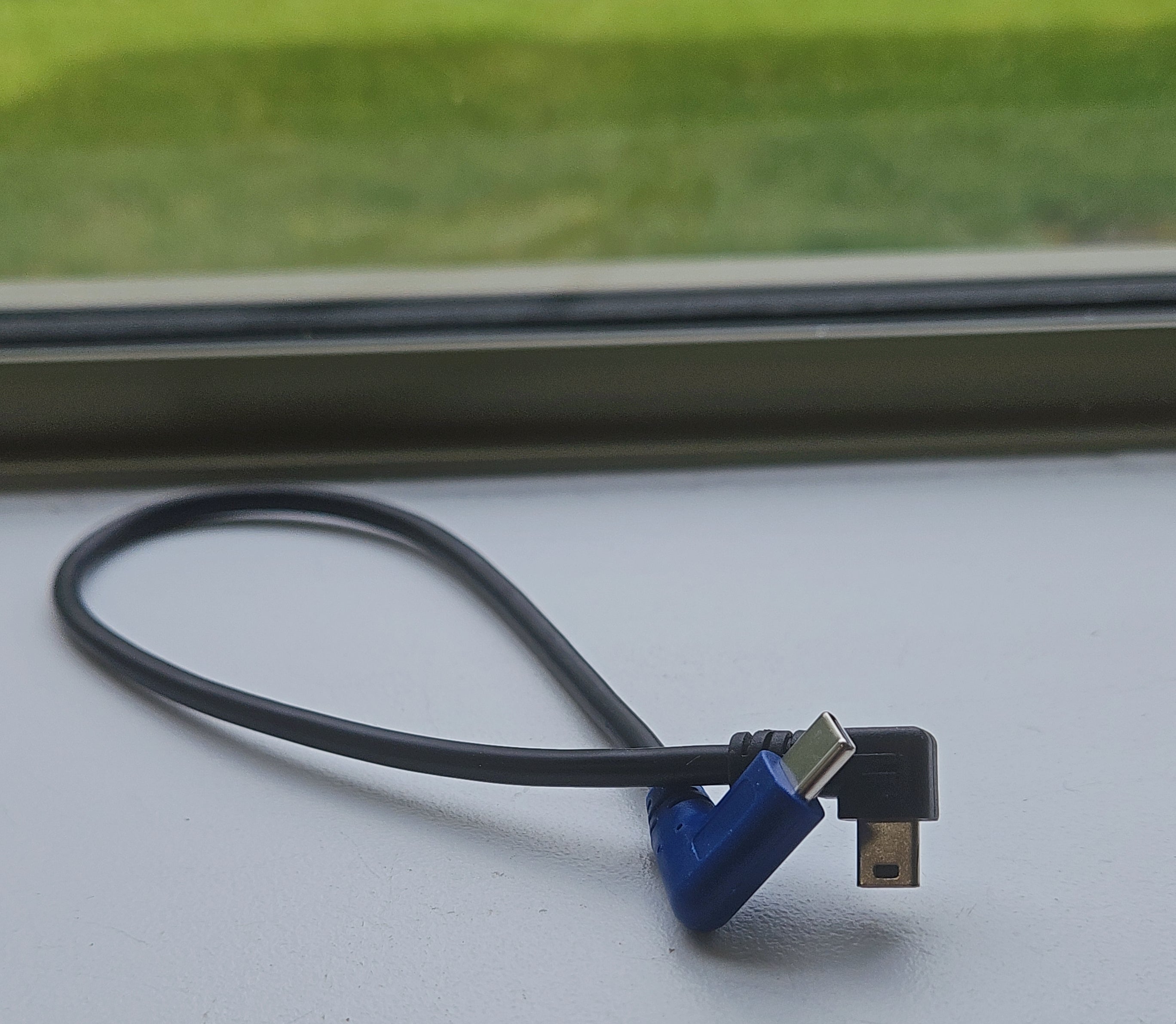 Cable with blue and silver connectors on a white surface