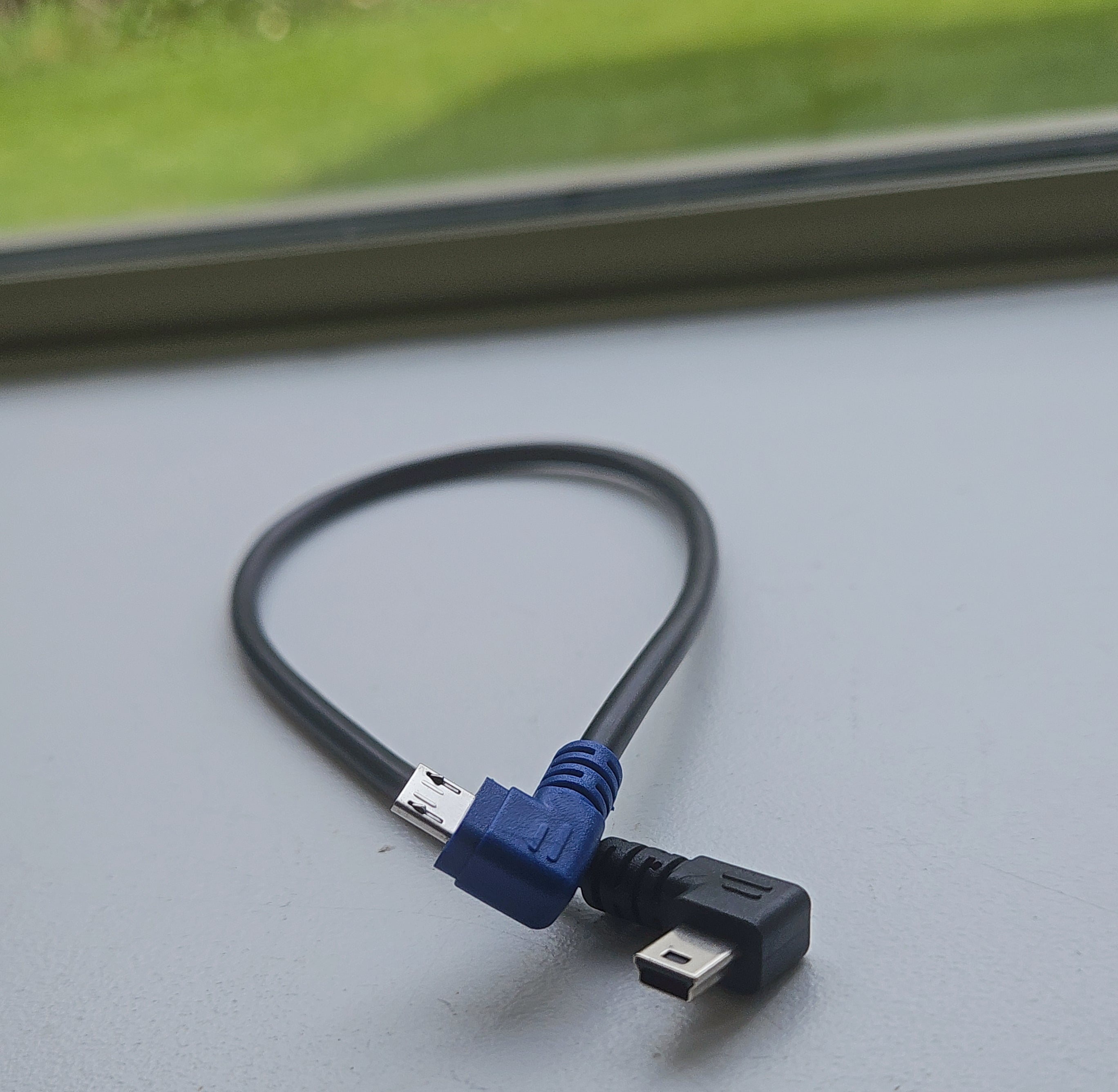 USB cable with blue connector on a gray surface