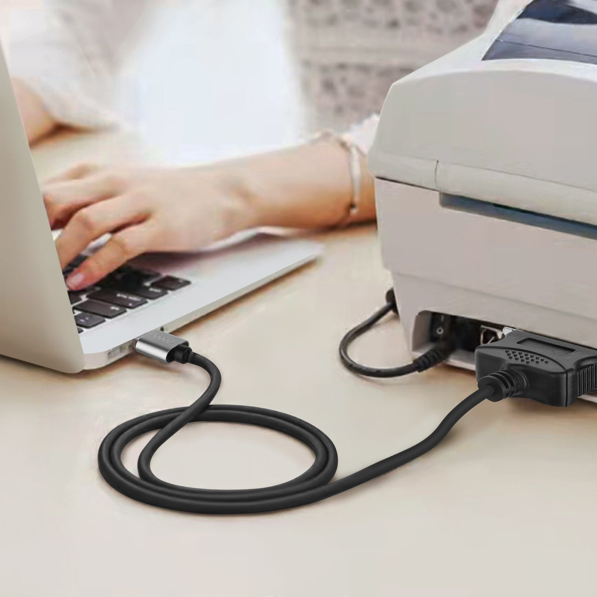 Cable connected between computer USB port and parallel printer.