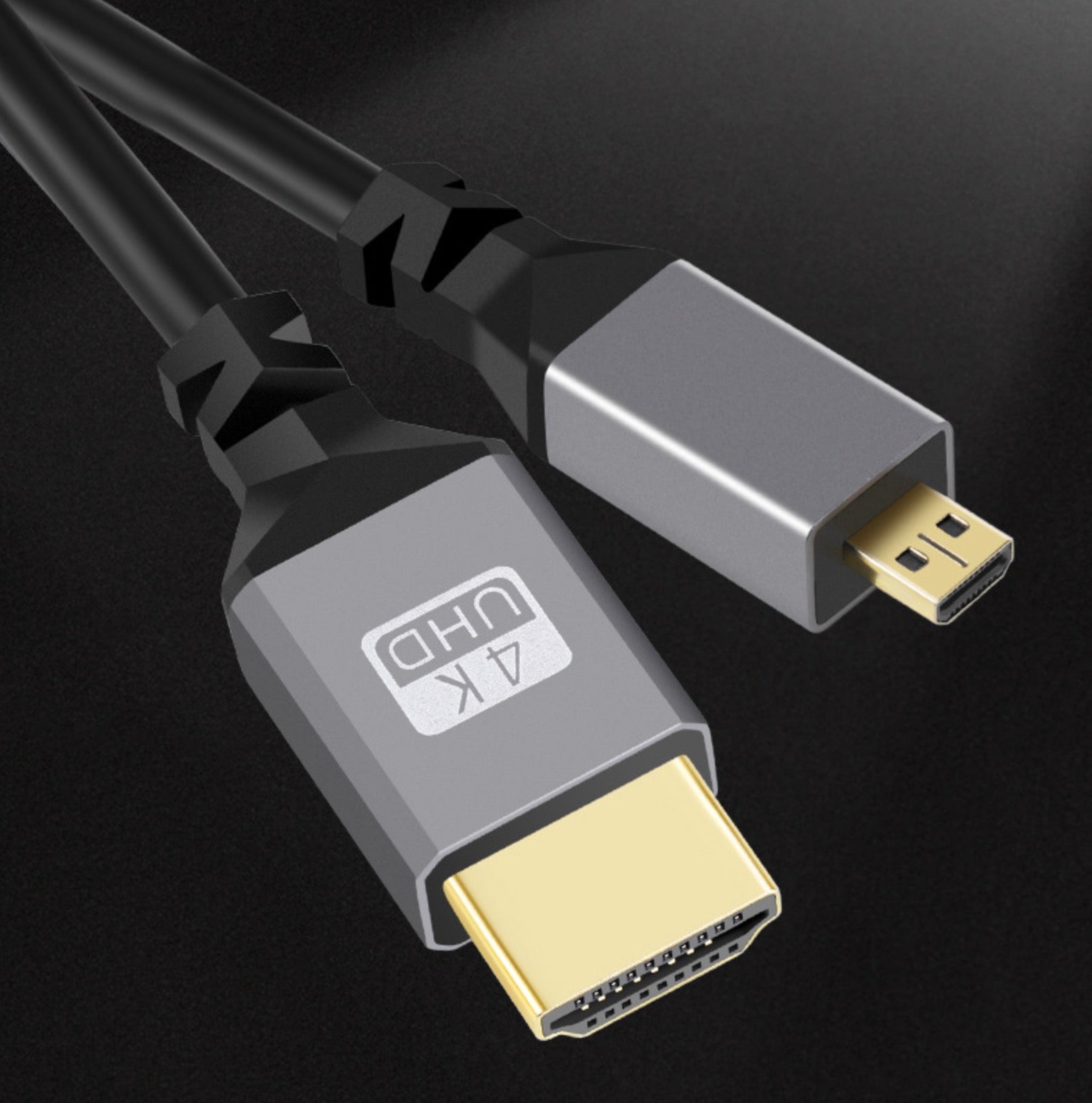 Close-up of gold-plated Micro HDMI and HDMI connectors on coiled cable