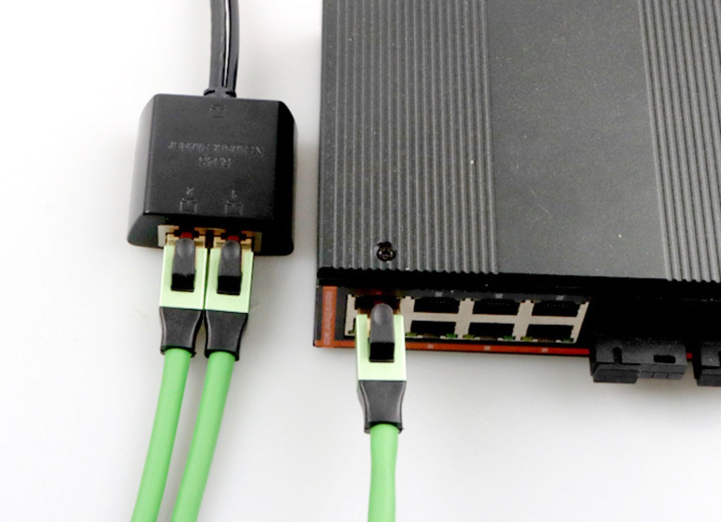Powered RJ45 splitter connected between Ethernet devices